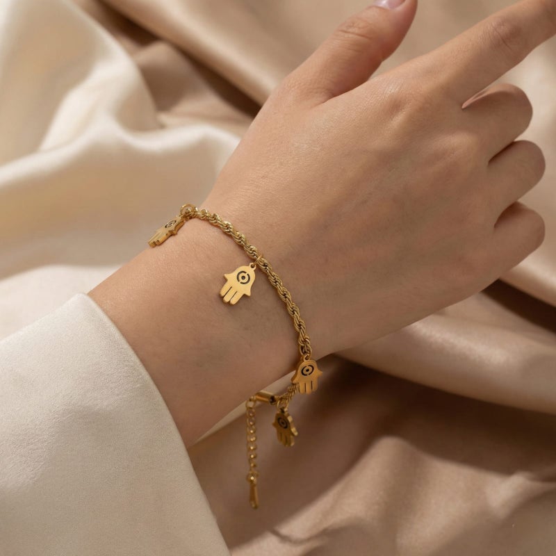 An elegant gold bracelet made of rust-resistant stainless steel, with a classic "braided" design from which five "hand of the hand" pendants dangle, with an adjustable clasp to suit you. - Image 2